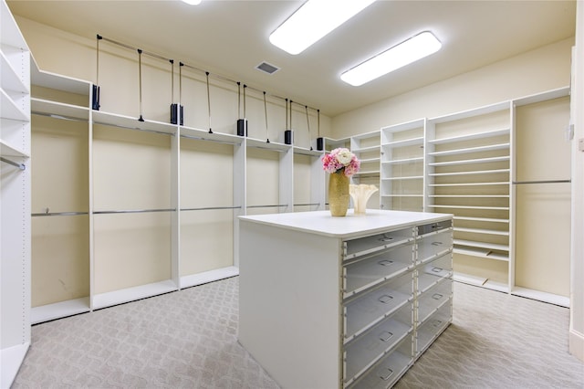 walk in closet featuring light carpet