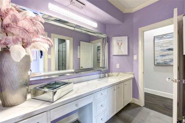 bathroom featuring crown molding and vanity