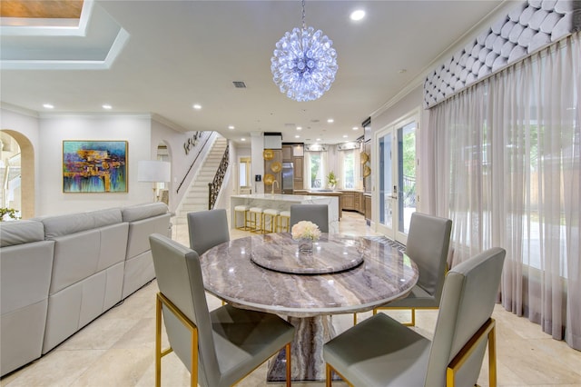 tiled dining room featuring ornamental molding and a chandelier