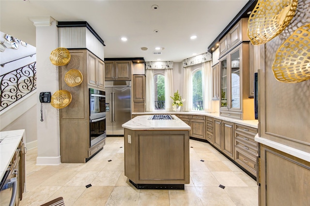 kitchen with a kitchen island, appliances with stainless steel finishes, and light tile patterned floors