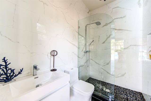 bathroom featuring toilet, sink, tile walls, and a tile shower