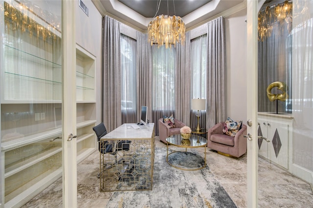 interior space featuring french doors, a chandelier, a raised ceiling, and built in features