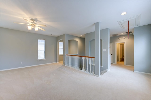 spare room featuring ceiling fan and light colored carpet