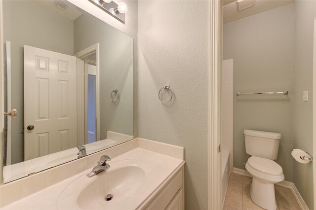 bathroom with vanity, tile patterned floors, and toilet