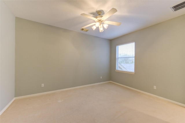 unfurnished room featuring light colored carpet and ceiling fan