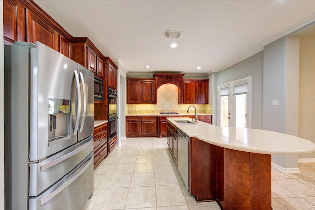 kitchen with light tile patterned floors, sink, a center island with sink, and black appliances