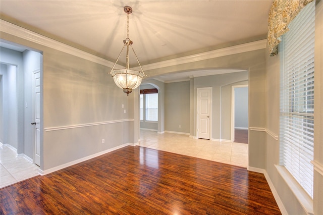 spare room with crown molding and light hardwood / wood-style floors