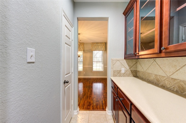 interior space featuring tasteful backsplash and light tile patterned flooring