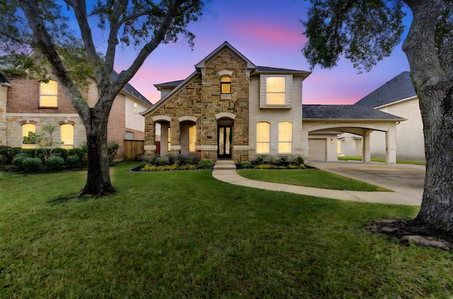 view of front facade with driveway, stone siding, and a front yard