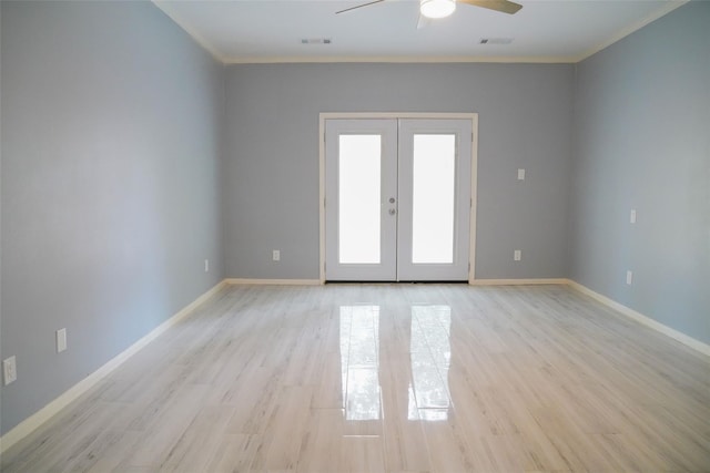 empty room featuring french doors, ceiling fan, ornamental molding, and light hardwood / wood-style floors