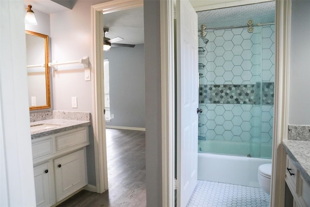 full bathroom featuring enclosed tub / shower combo, ceiling fan, tile patterned flooring, vanity, and toilet