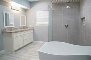 bathroom with vanity, wood-type flooring, and independent shower and bath