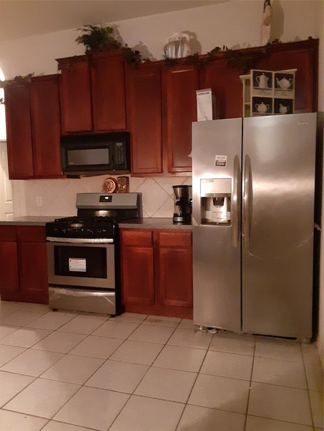 kitchen featuring tasteful backsplash, stainless steel appliances, and light tile patterned flooring