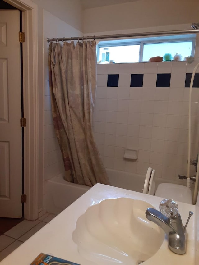 bathroom with shower / tub combo, tile patterned flooring, and sink