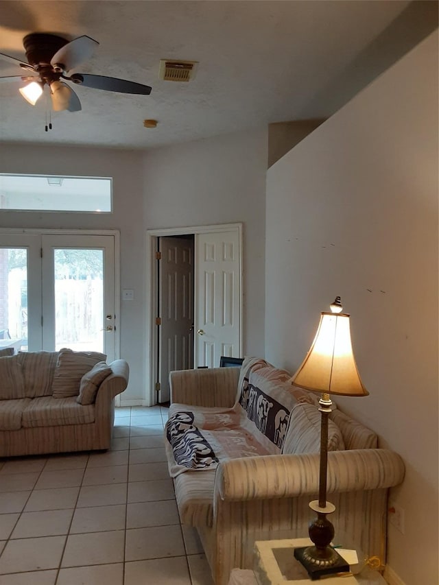 living room featuring light tile patterned floors and ceiling fan