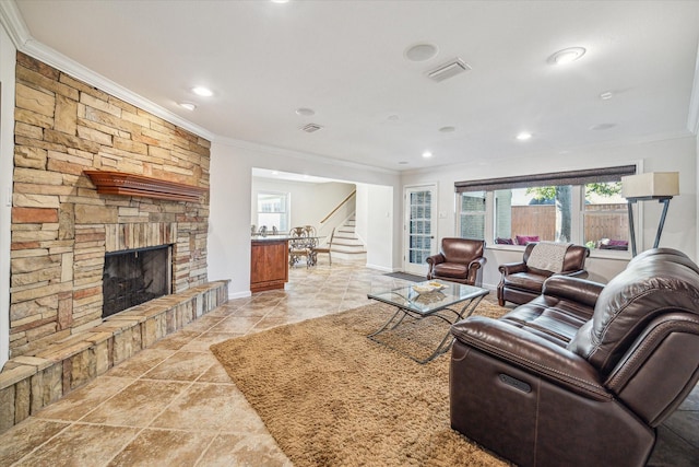 tiled living room featuring ornamental molding and a fireplace