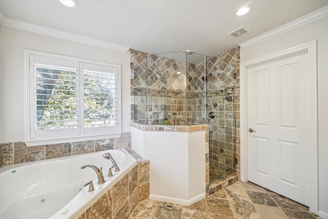 bathroom with ornamental molding and shower with separate bathtub