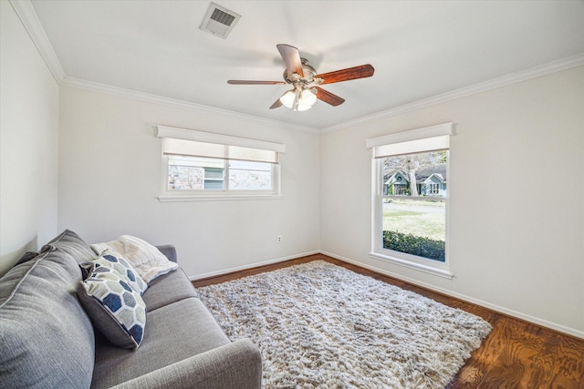 living room featuring crown molding, dark wood-type flooring, and ceiling fan