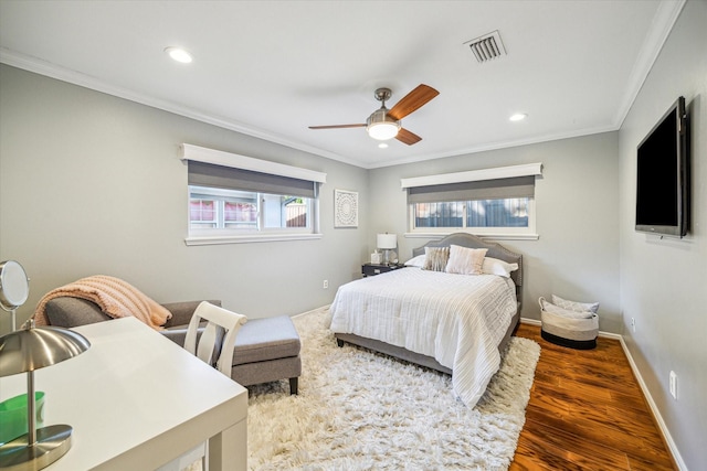 bedroom featuring dark wood-type flooring, ceiling fan, and ornamental molding