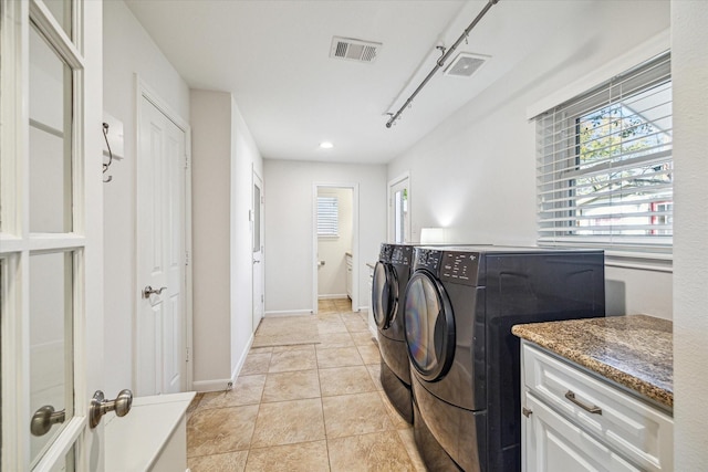 washroom with light tile patterned flooring and washer and dryer