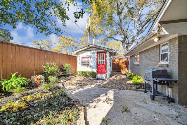 view of yard with a shed and a patio