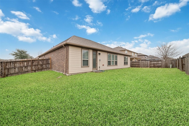 back of house featuring a lawn