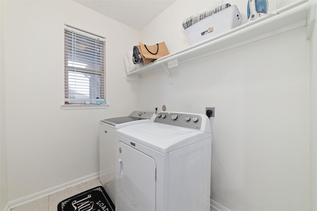 washroom with tile patterned flooring and washer and dryer