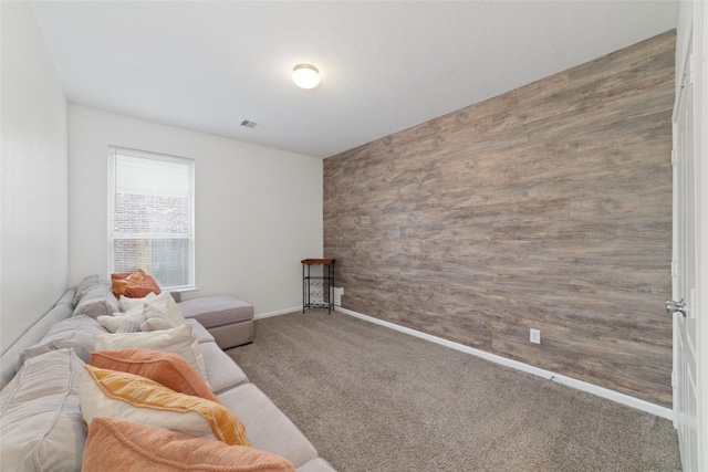 living room with wooden walls and carpet flooring