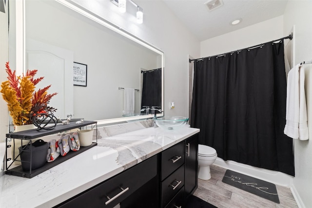 bathroom featuring vanity, hardwood / wood-style floors, and toilet