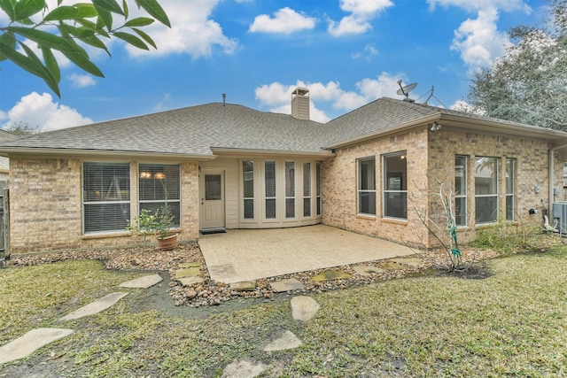 back of property featuring a patio area and a lawn