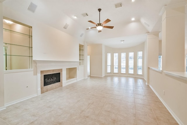 unfurnished living room featuring light tile patterned flooring, a tile fireplace, vaulted ceiling, and built in features