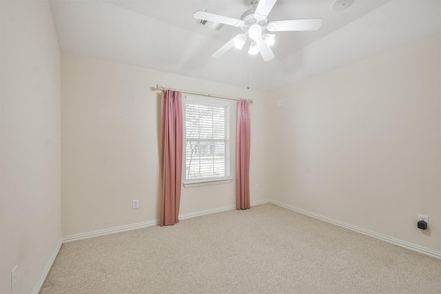 carpeted spare room with ceiling fan