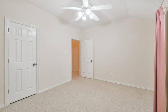 unfurnished bedroom with light carpet, lofted ceiling, and ceiling fan