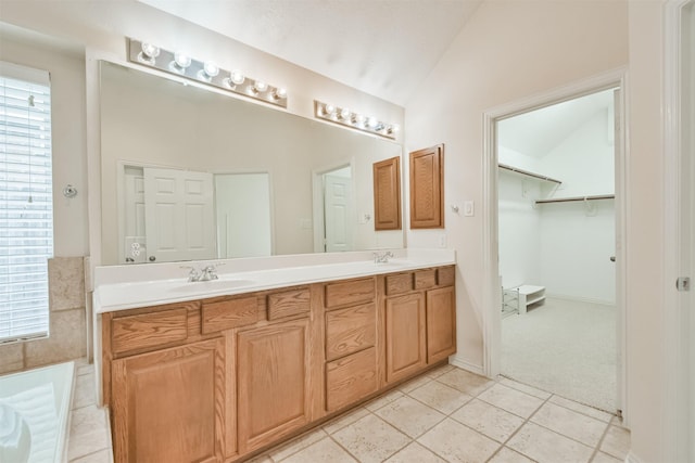 bathroom featuring lofted ceiling, tile patterned flooring, and vanity