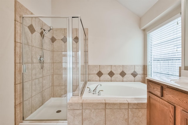 bathroom with vanity, independent shower and bath, and vaulted ceiling