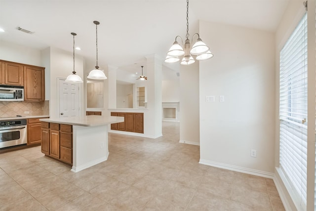 kitchen with tasteful backsplash, a center island, vaulted ceiling, hanging light fixtures, and stainless steel appliances