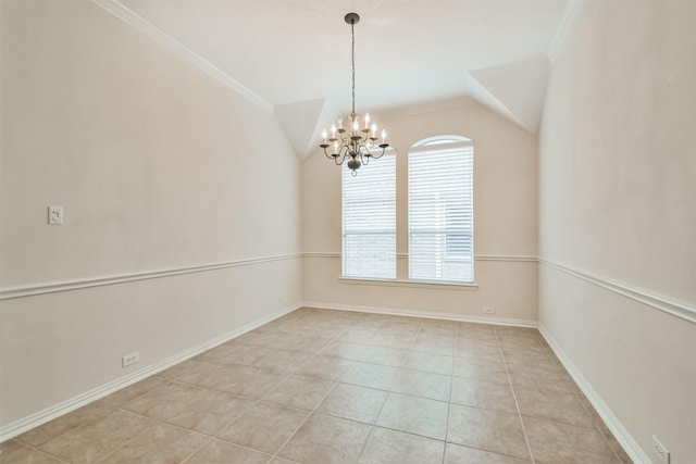 tiled spare room with lofted ceiling, ornamental molding, and a chandelier