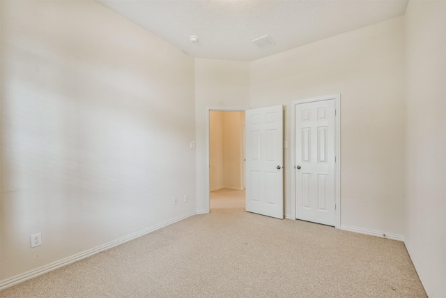 unfurnished bedroom featuring light colored carpet