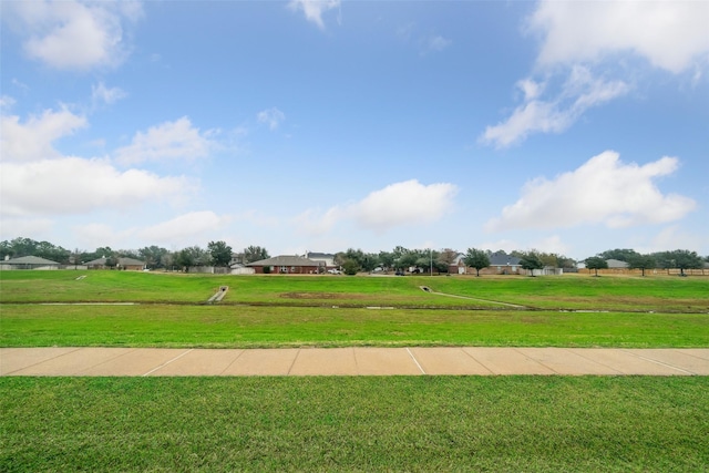 view of property's community featuring a yard