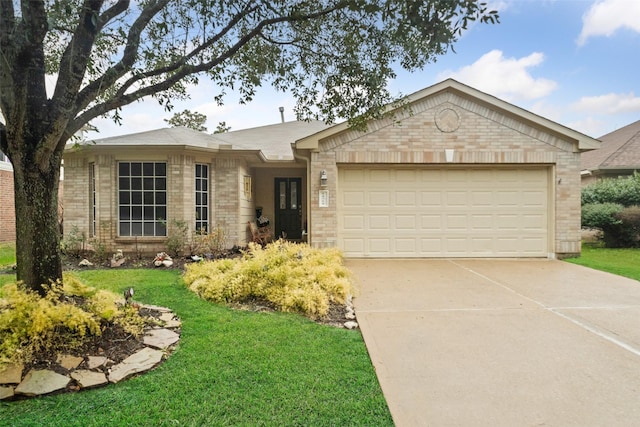 single story home featuring a garage and a front lawn