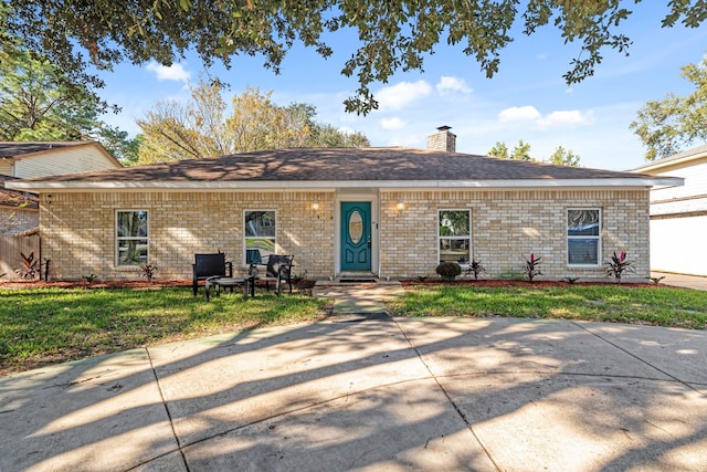 ranch-style home with a front lawn