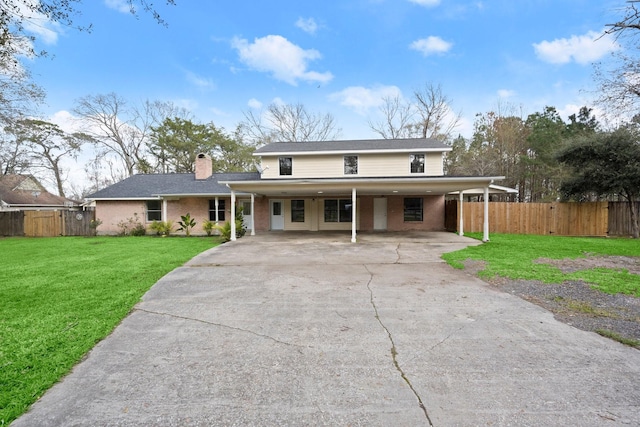 view of front of house with a carport and a front lawn