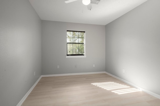 spare room with ceiling fan and light wood-type flooring