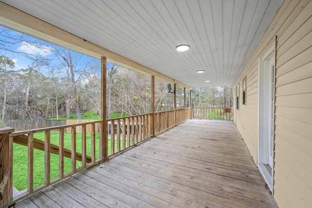 wooden terrace with a lawn