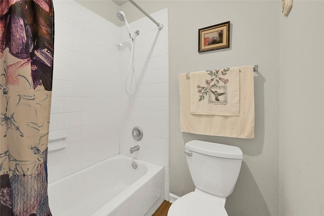 bathroom with shower / tub combo with curtain and toilet