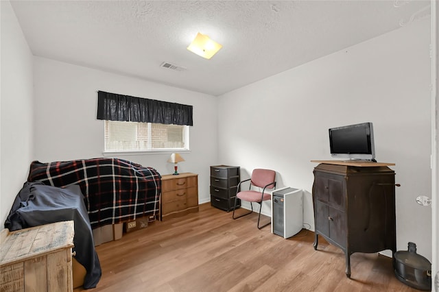 office featuring light hardwood / wood-style flooring and a textured ceiling