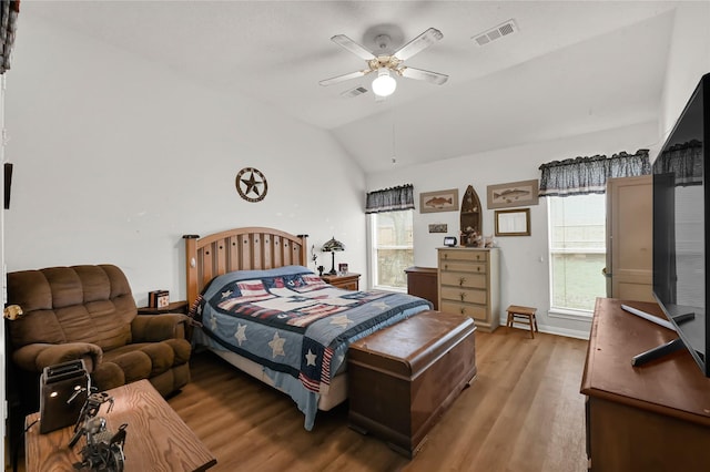 bedroom featuring multiple windows, vaulted ceiling, light hardwood / wood-style floors, and ceiling fan