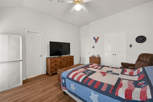 bedroom with lofted ceiling, hardwood / wood-style flooring, a closet, and ceiling fan