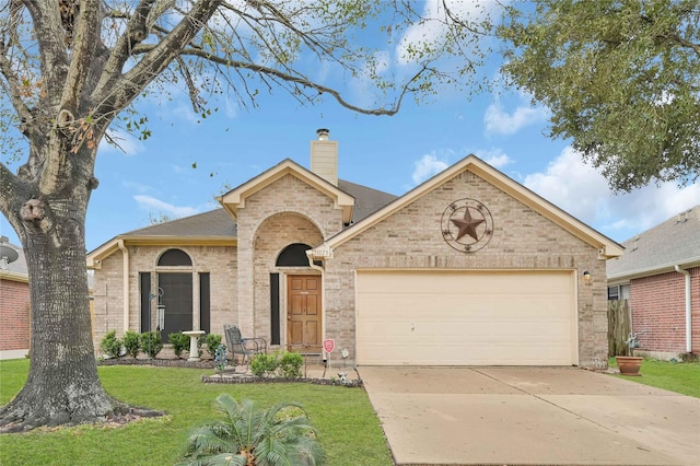 view of front of house featuring a garage and a front yard