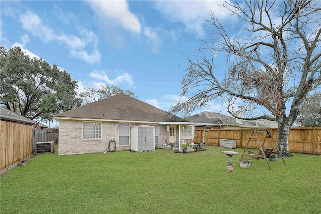 rear view of property with cooling unit and a lawn